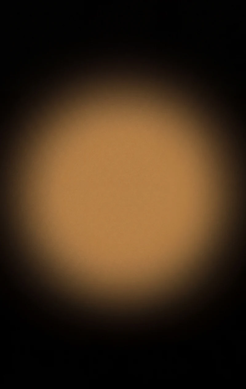 AMOLED & Dark wallpaper fitted to the Galaxy Z Fold 8 cover display — a soft amber halo centred in an empty field of near-black