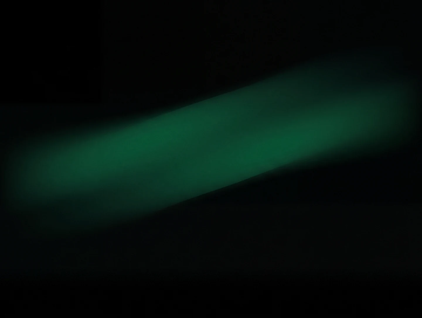 AMOLED & Dark wallpaper fitted to the Galaxy Z Fold 8 main display — soft diagonal emerald band drifting through the upper middle of a black field
