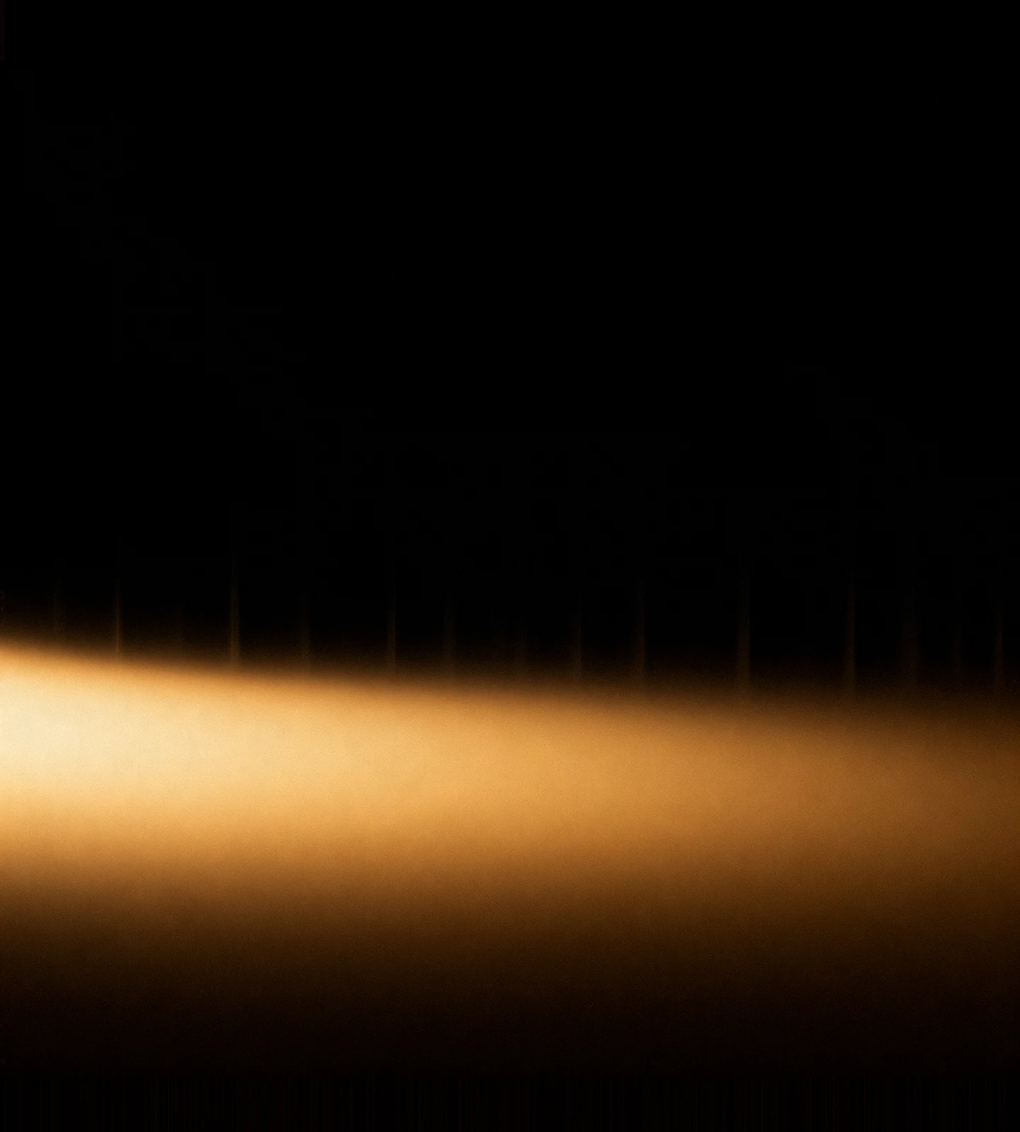 AMOLED & Dark wallpaper fitted to the Galaxy Z Fold 8 Ultra inner display — a low amber-gold haze pooled near the bottom, brightest left of centre