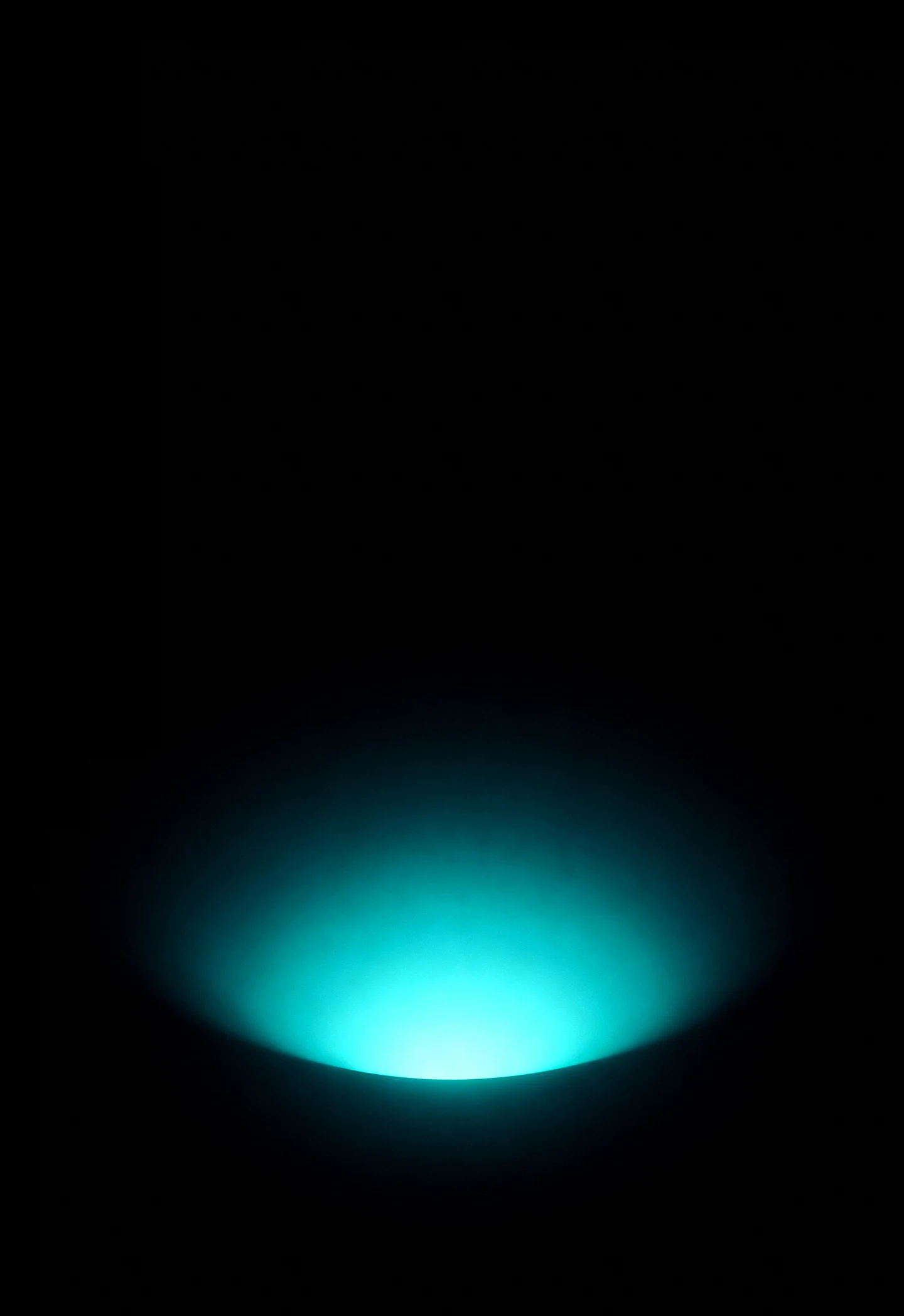 AMOLED & Dark wallpaper fitted to the iPhone Duo outer display — a soft deep-teal glow rising from the lower edge and fading up into pure black