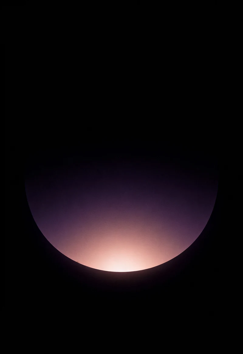AMOLED & Dark wallpaper fitted to the iPhone Duo outer display — a soft mauve mist glowing low against deep black, held in plain dark space
