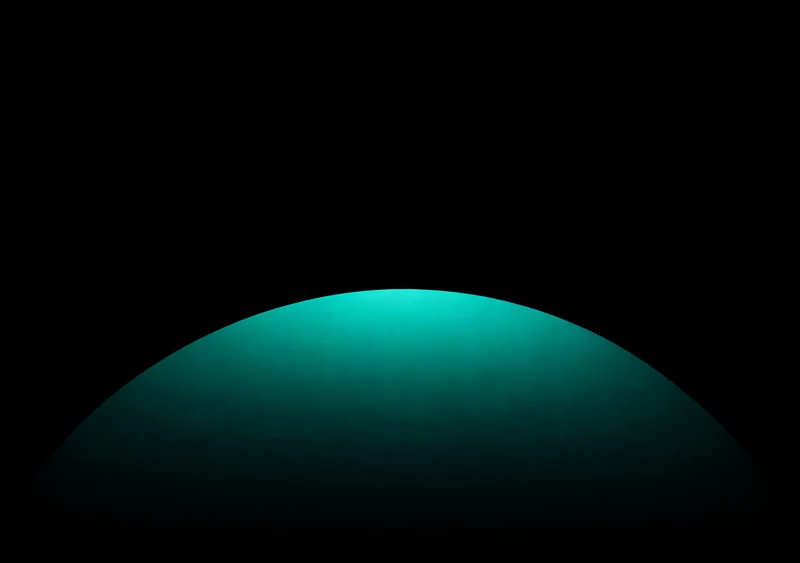 AMOLED & Dark wallpaper fitted to the iPhone Duo inner display — a single soft jade-green dome rising low, crest near the middle