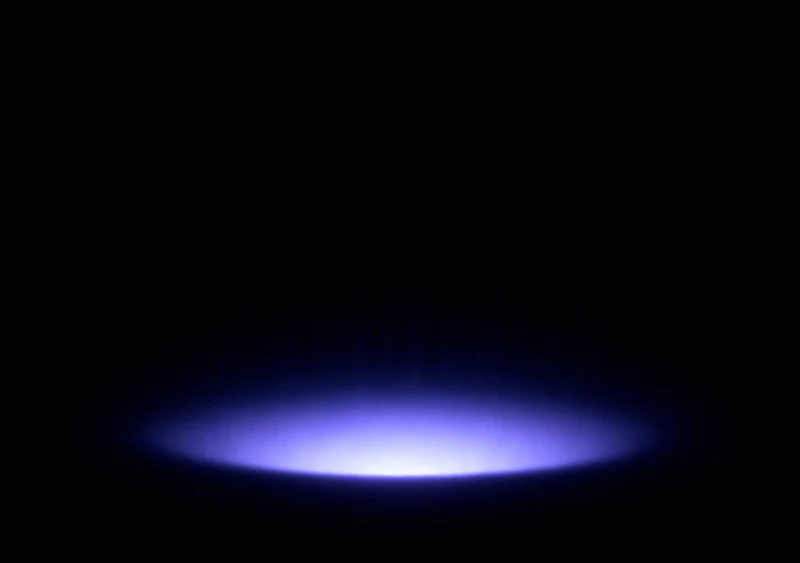 AMOLED & Dark wallpaper fitted to the iPhone Duo inner display — a single soft indigo elliptical halo glowing low on pure black