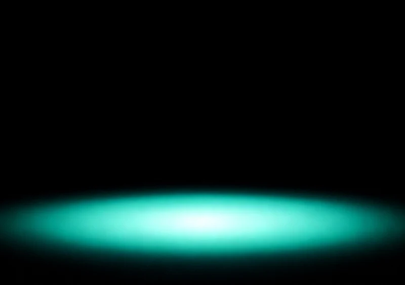 AMOLED & Dark wallpaper fitted to the iPhone Duo inner display — a soft mint halo of light glowing low on deep black, wrapped in dark space